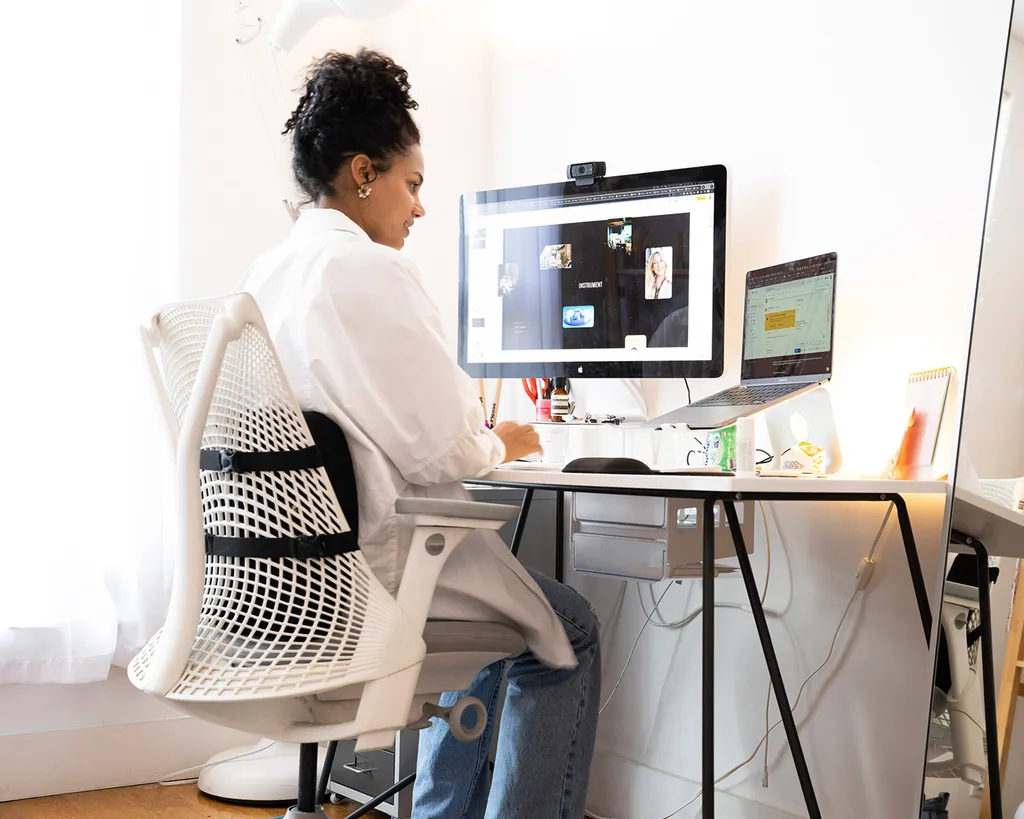 Image of Instrument employee sitting at a desk and collaborating